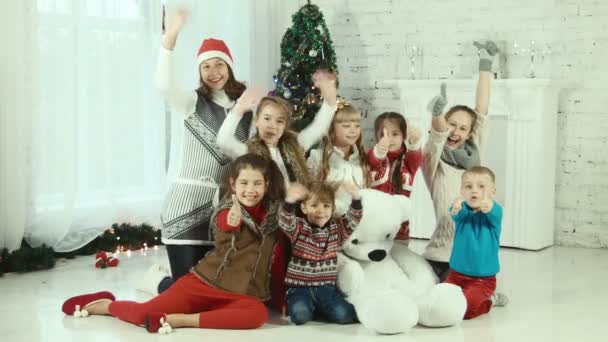 Grupo de niños en el fondo del árbol de Navidad — Vídeos de Stock