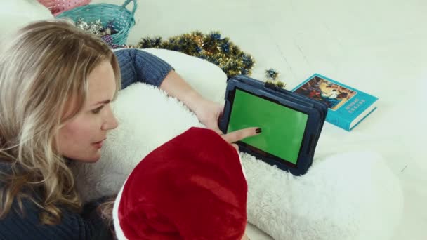 Moeder leest een verhaal van Kerstmis met touchpad met greenscreen — Stockvideo