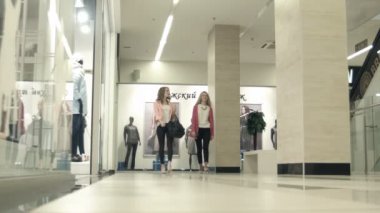 Kız alışveriş merkezi üzerinde yürümek ve dükkana gelip