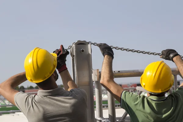 workers building stage truss construction