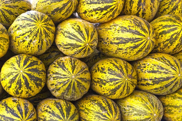 melons piled up on market