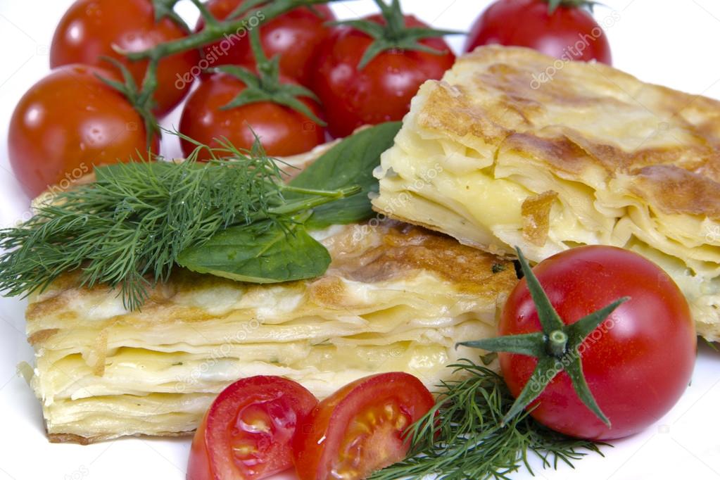 Turkish cheese pie borek with tomatoes isolated on white background