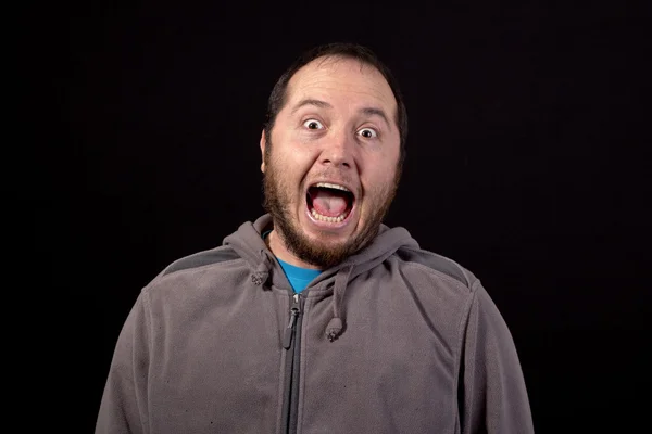 Man laughing out loud isolated on black background — Stock Photo, Image