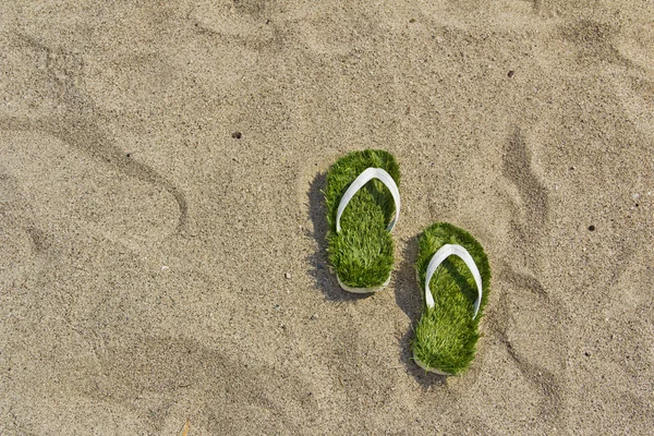 Grass flip flops sandals on the beach — Stock Photo, Image