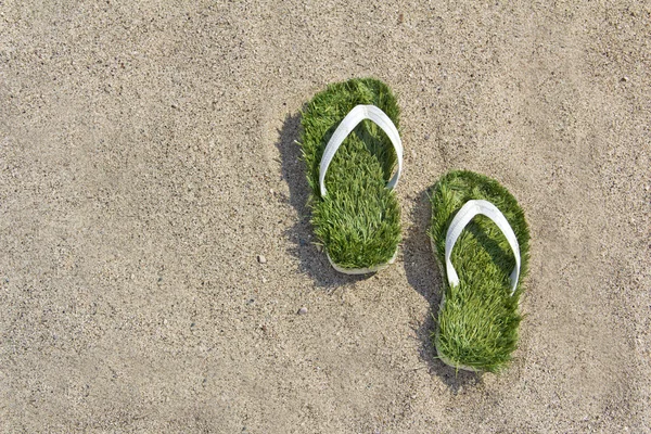 Grass flip flops sandals on the beach — Stock Photo, Image