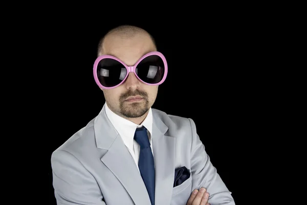 Businessman wearing big funky glasses isolated on black background — Stock Photo, Image
