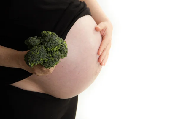 Pregnant woman holding broccoli in hand isolated on white background — Stock Photo, Image