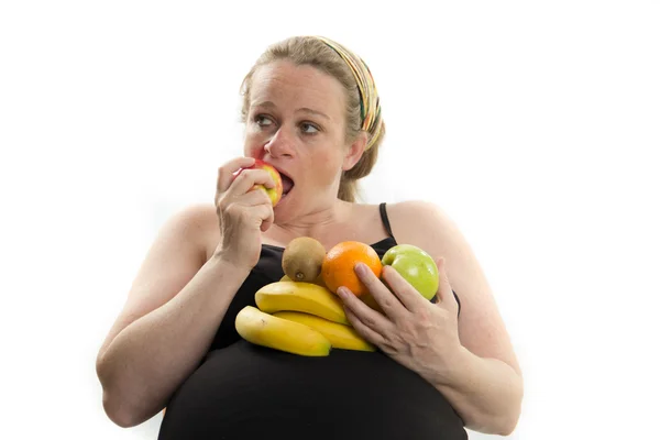 Pregnant woman eating fruit isolated on white background — Stock Photo, Image