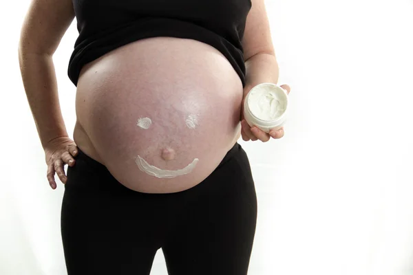 Pregnant belly stretch mark cream happy face isolated on white background — Stock Photo, Image