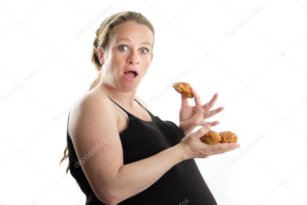 pregnant woman eating croissant isolated on white background