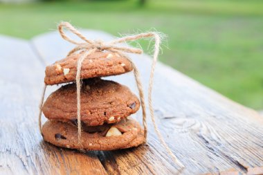 A heap of chocolate chip cookies on a  wooden table 