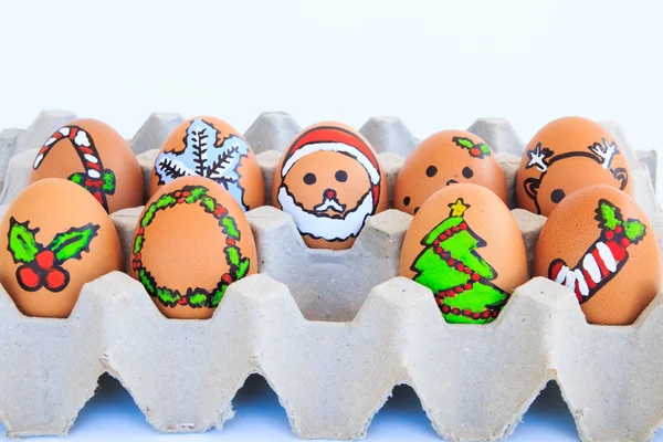 Christmas egg with faces drawn arranged in carton