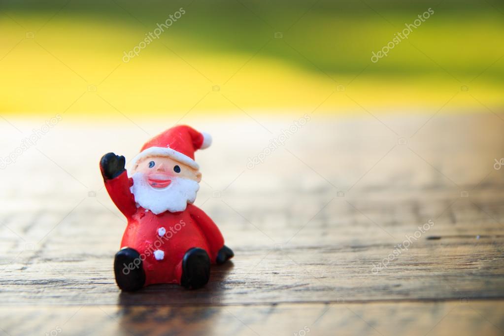Santa Claus  on wood table ,in garden background