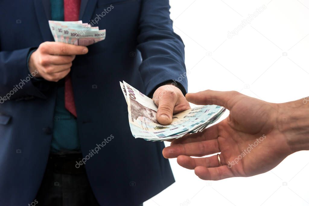 businessman gives or takes a bribe of money. Ukrainian hryvnia, new banknotes of 1000 hryvnia. Save or corruptionconcept. 