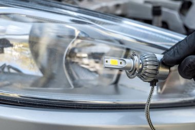 Profesyonel işçi yeni halojen ampullerin arabasını değiştiriyor. otomatik onar