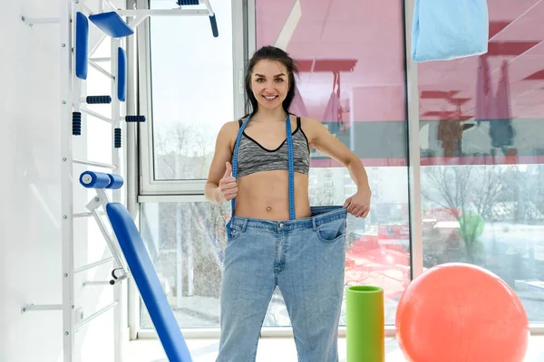 Kvinna Överdimensionerade Jeans Poserar Gym — Stockfoto