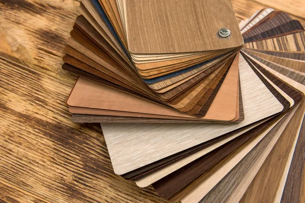 Variety of wooden like tiles. Samples of fake wood tiles for flooring.  Assortment of floor laminate / tiles in an interior shop. Stock Photo