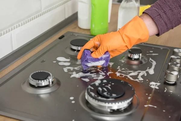 Cleaning in the kitchen gas stone with foam and sponge. Domestic equipment for health lifestyle