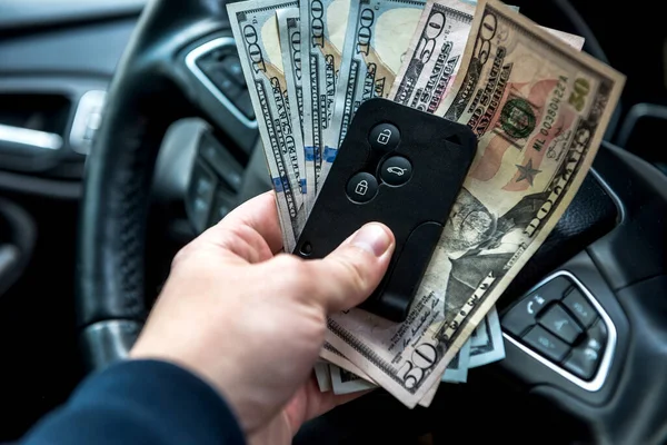 man hold dollar and car key for pay rent or bribe. finance