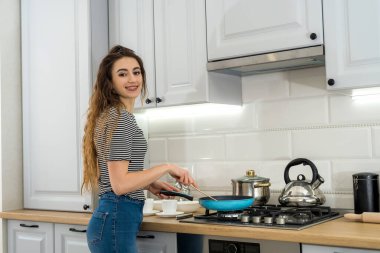 Mutlu genç bayan mutfakta lokantayı hazırlıyor. Sağlıklı kadın yaşam tarzı. Diyet