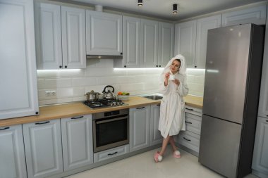 Muhteşem kadın sabah mutfakta dinleniyor ve kahvenin tadını çıkarıyor. Rahat ev eğlencesi.. 