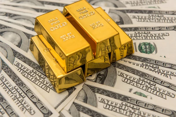 gold bullion bars on usd money bills. Success concept. Investment
