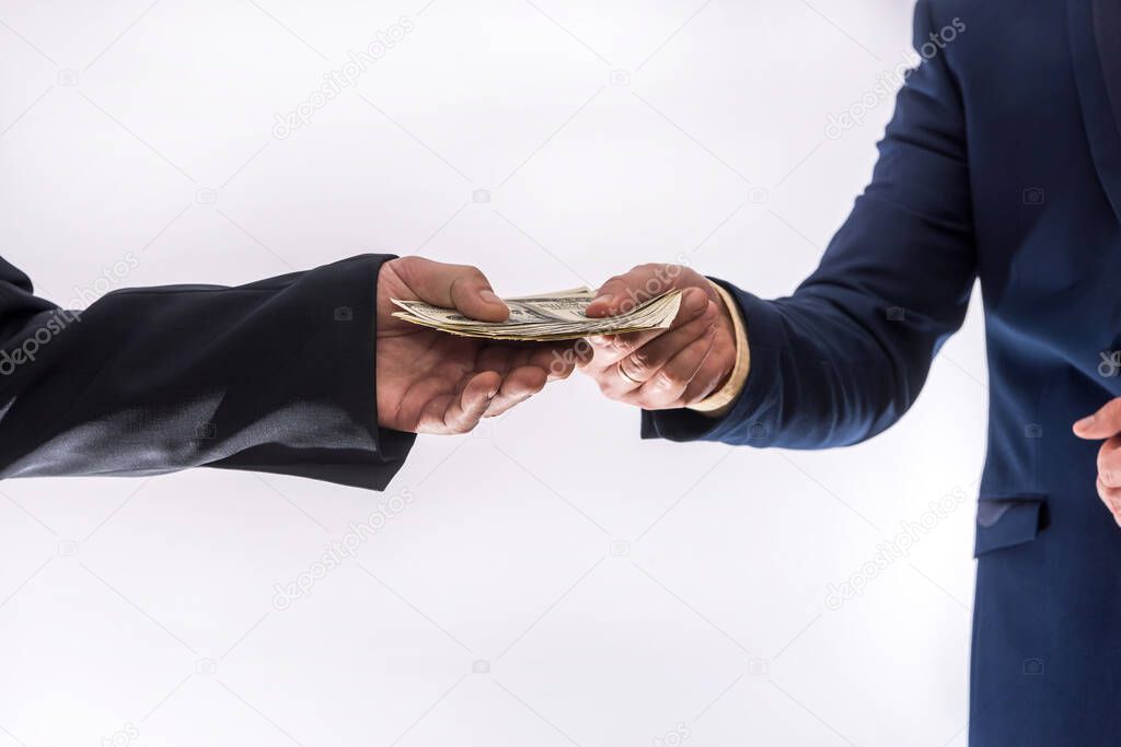 Transfer of money between two businessmen. Male's hand giving 100 dollar isolated on gray. finance