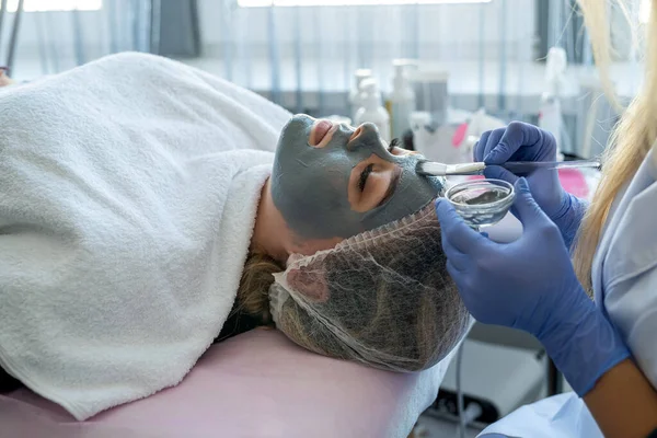 Closeup Hands Beautician Blue Gloves Applying Beauty Mask Face Girl — Stock Photo, Image