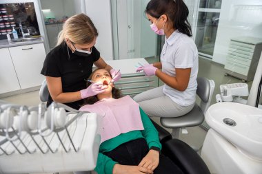 Doktor, muayene için dişçi aletlerini hastanın ağzının yakınında tutuyor. sağlık hizmeti kavramı