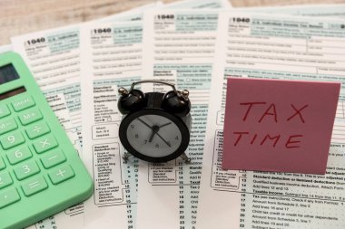 Saat kalemi ve hesap makinesi 1040 formunda. Vergi doldurma kavramı  