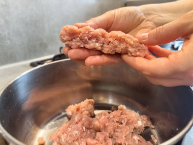 Kadın elleri taze köfteler için kıyma öğütüyor. Çiğ taze kıyma.