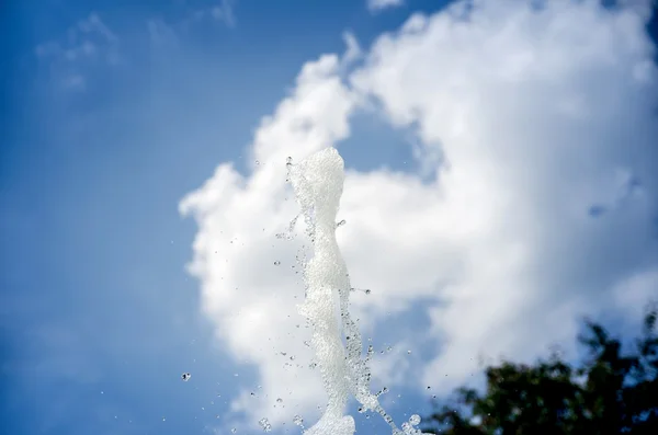 Water droplets against blue sky