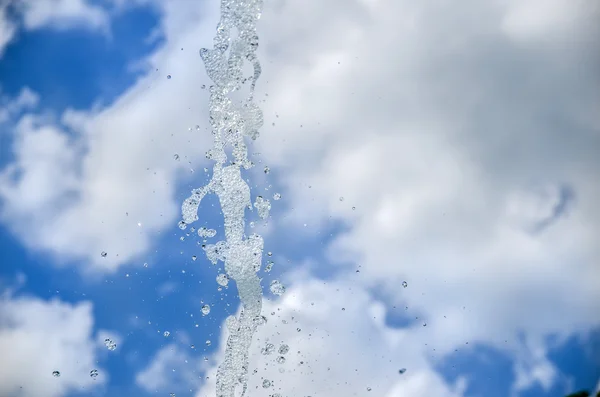 Water droplets against blue sky