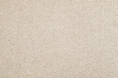 Lifli yüzeyi olan bej renkli karton dokunun yakın çekimi. Çevre tasarımı, baskı, paketleme veya çevre dostu tasarım kavramları için nötr organik arkaplan.