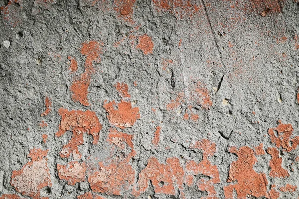 Çatlak ve pul pul dökülen kırmızı boyalı eski beton yüzey. Grunge dokusu arka plan, örtüler ve yaratıcı tasarım projeleri için mükemmeldir..