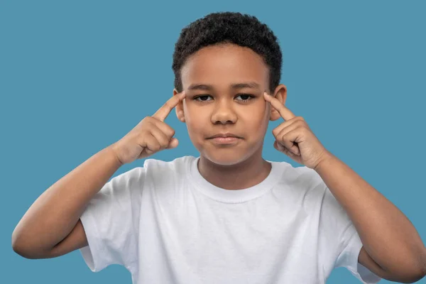 Sad boy touching his head with fingers — Φωτογραφία Αρχείου