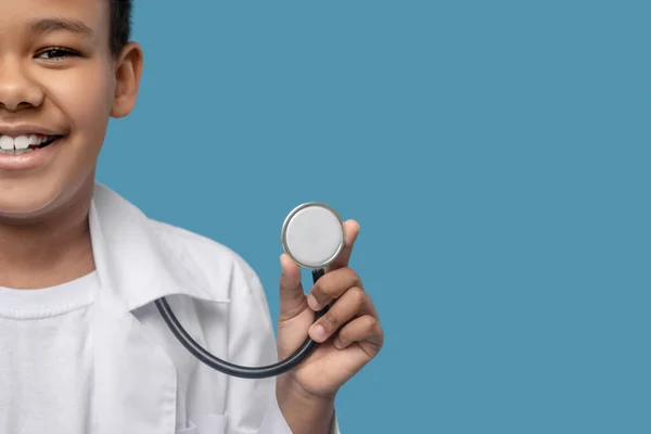 Close up half face of laughing boy with stethoscope — Φωτογραφία Αρχείου