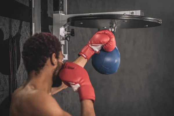 African american kickboxer exercising in a gym working on his kicks — Stock Photo, Image