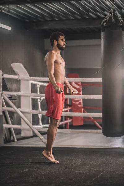 Man in red shorts skipping before the workout