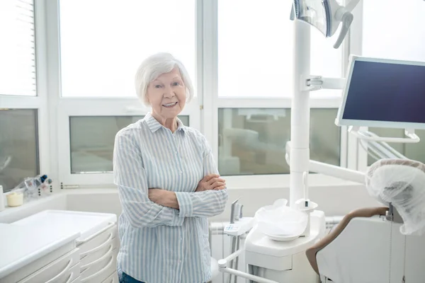 Mulher idosa de cabelos curtos no consultório de dentistas — Fotografia de Stock