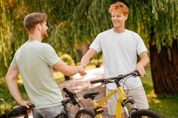 二人の自転車乗りが外で挨拶する — ストック写真