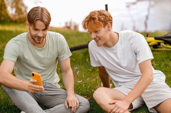 Two pals viewing pictures on the smartphone