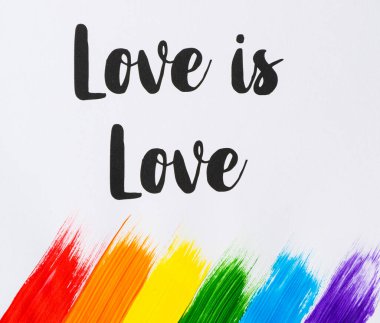Aşk, LGTBI renkleri, kırmızı, turuncu, sarı, yeşil, mavi ve mor akrilik boya ve fırçayla yapılmış aşk sloganıdır. Gurur Günü