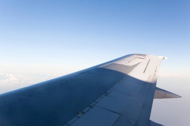 Gökyüzünde kanat ve uçuş sırasında bulutlar.