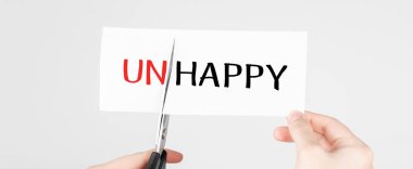 Beyaz kağıt kesen makas. Mutsuz, kelimeyi Happy olarak değiştir..
