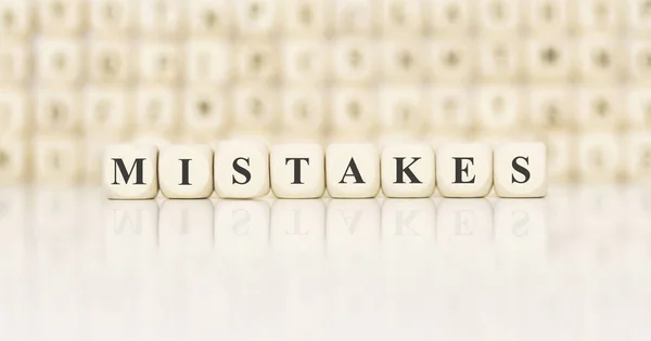 Word MISTAKES made with wood building blocks