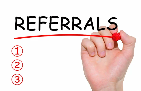 Hand writing Referrals with red marker on transparent wipe board. — Stock Photo, Image