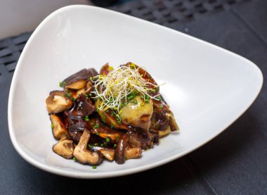 Şık bir restoranda mantar servis eden bir gurmenin yakın çekimi.