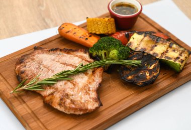 Tahtada sebzeli ızgara domuz eti.