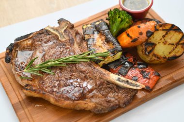 Biberiyeli biftek ve tahta tahtada sebze..